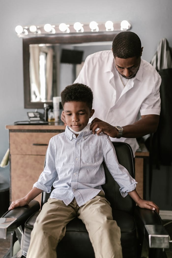 Barber School Near Me: How to Choose the Best Path to Becoming a Professional Barber 3 Barber cutting a child