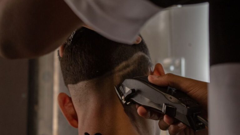 Quietest Cordless Clippers for Barbers: What to Buy in 2026 10 Barber using a clipper on the back of a client's head, leaving a faded pattern
