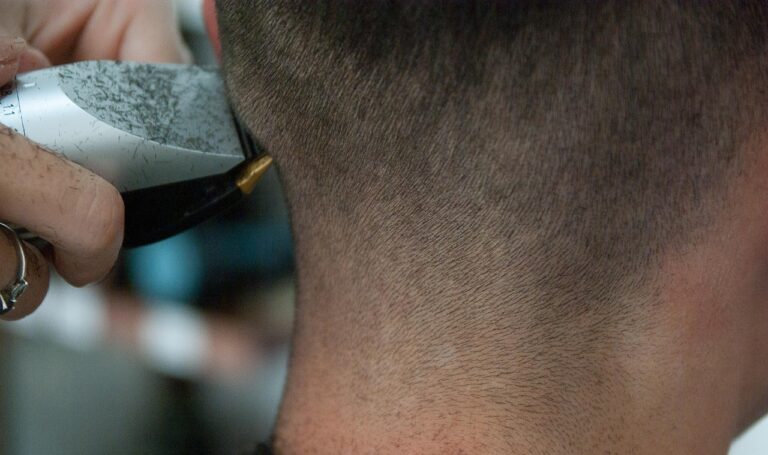 How to Cut a Fade at Home: A Beginner's Guide (2026) 8 Barber clippers cutting the nape during a fade haircut